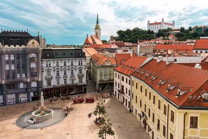 Bratislava Old Town skyline with red roofs and castle view, highlight of a private day trip from Vienna