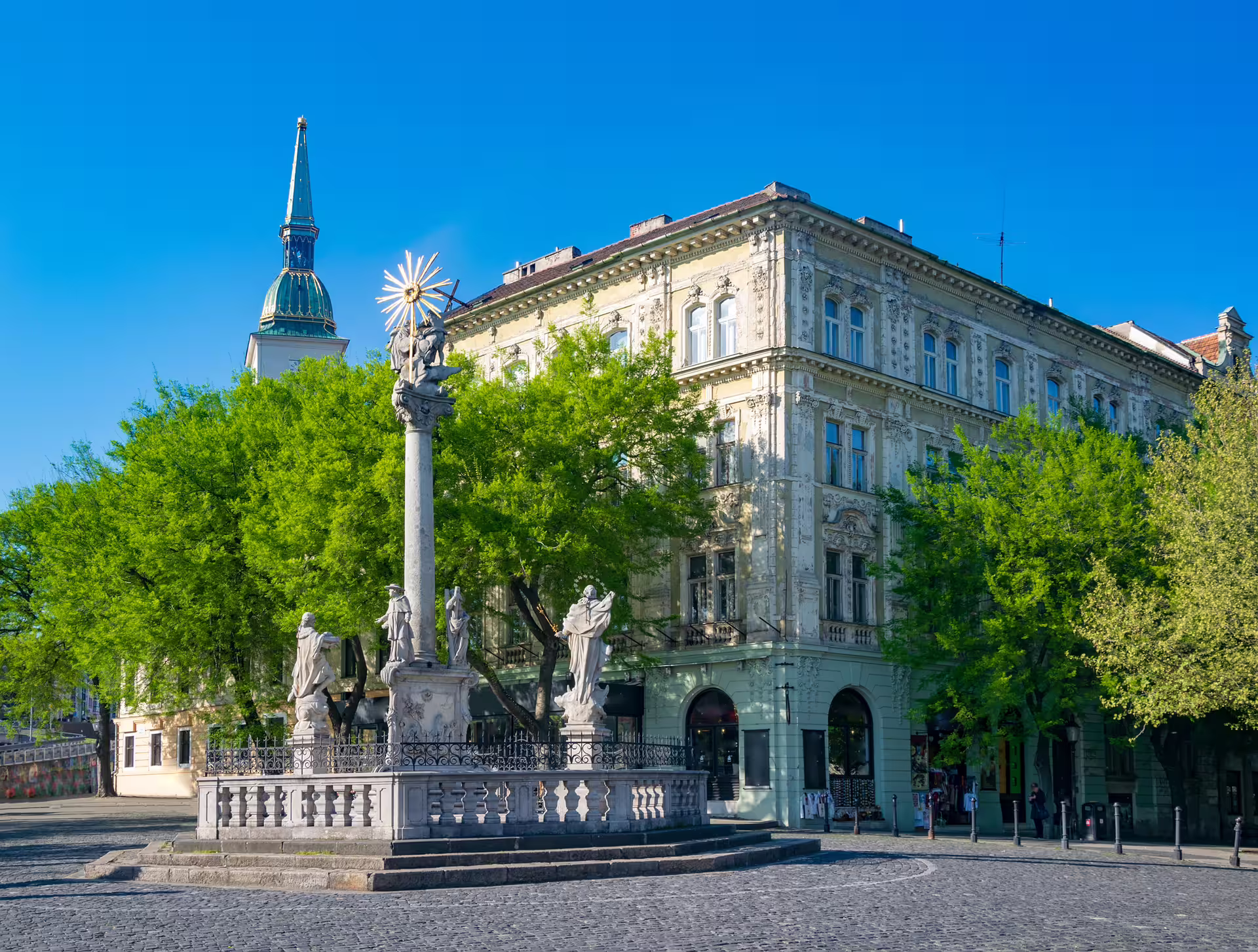 Trinity Column and St Martin’s Cathedral spire in Bratislava Old Town, key stop on 1-day audio walking tour