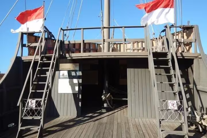 Historic ship deck with red and white flags on the Brazil Imperial, Rio boat tour around Guanabara Bay.