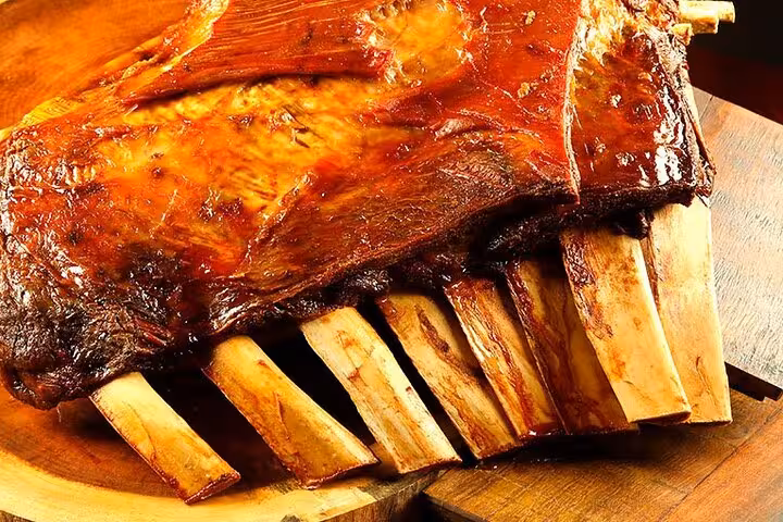 Juicy Brazilian BBQ ribs on a wooden platter, perfect for Rio's gourmet dining experiences and culinary tours.