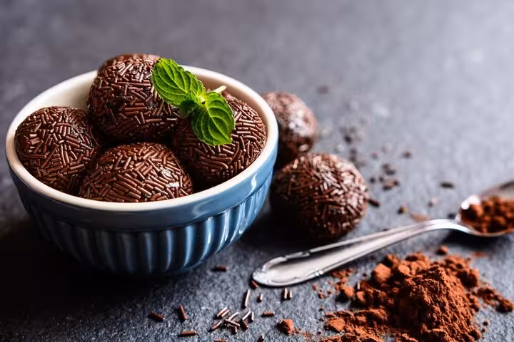 Bowl of Brazilian brigadeiros with mint, perfect for Rio's Cookin' Good: 9-Dish & Caipis Fiesta.