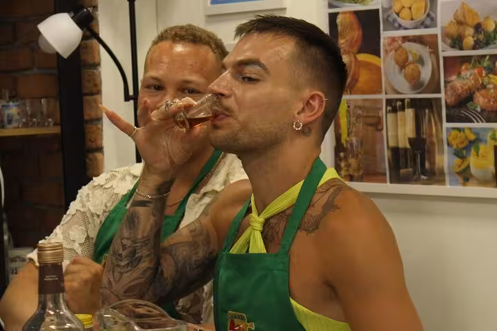 Two men savor Brazilian cocktails during a tasting session, enjoying the vibrant flavors and atmosphere.