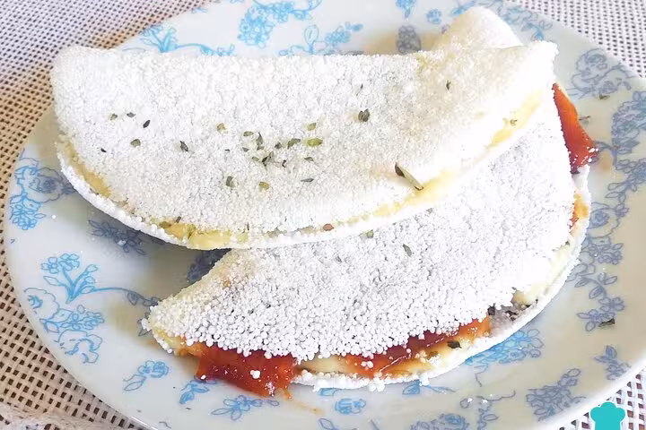 Traditional Brazilian tapioca with cheese and guava paste on a floral plate, perfect for a Rio cooking class.