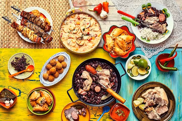Vibrant Brazilian feast featuring feijoada, skewers, and diverse traditional dishes on a colorful table setting.
