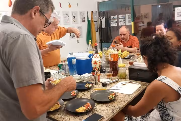 People preparing vibrant Brazilian dishes in a communal setting, showcasing traditional flavors and cooking techniques.
