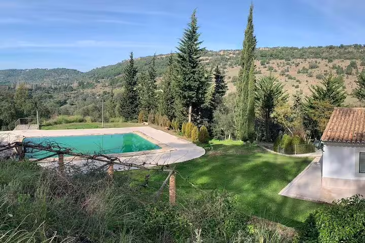 Scenic countryside view with a serene pool and lush greenery at Bread, Wine & Cheese, The Natural Taste tour venue.