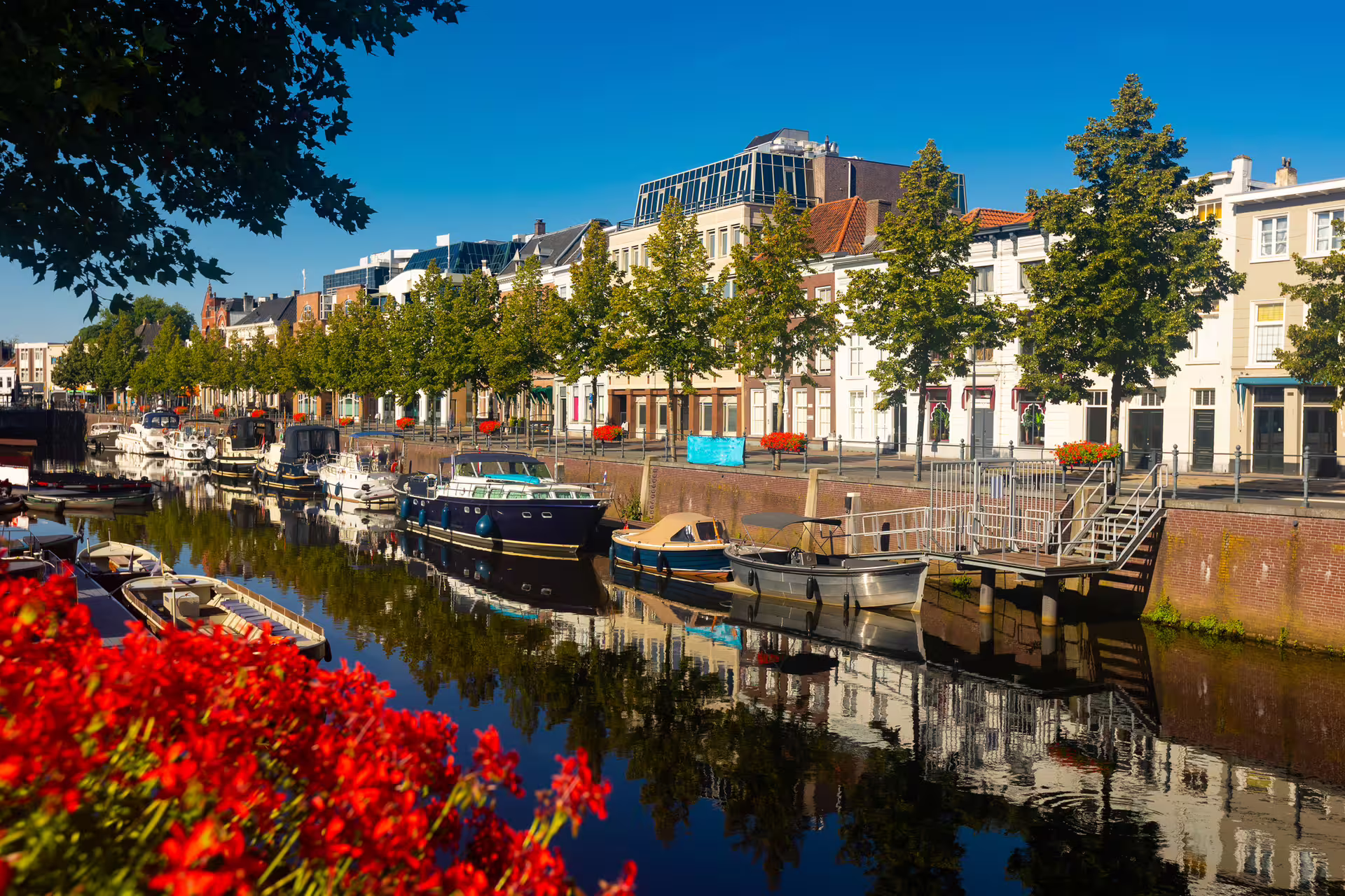Breda harbor canal with moored boats and historic buildings, featured on the Breda in 1 day walking tour audioguide