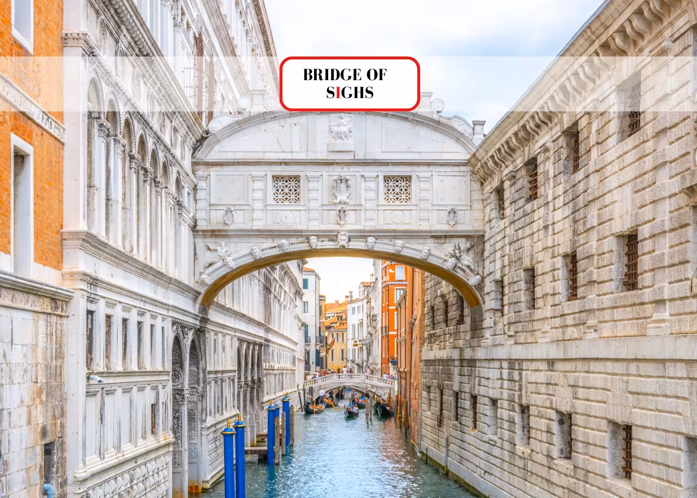 The iconic Bridge of Sighs arches over a canal, connecting historic buildings in Venice's charming landscape.