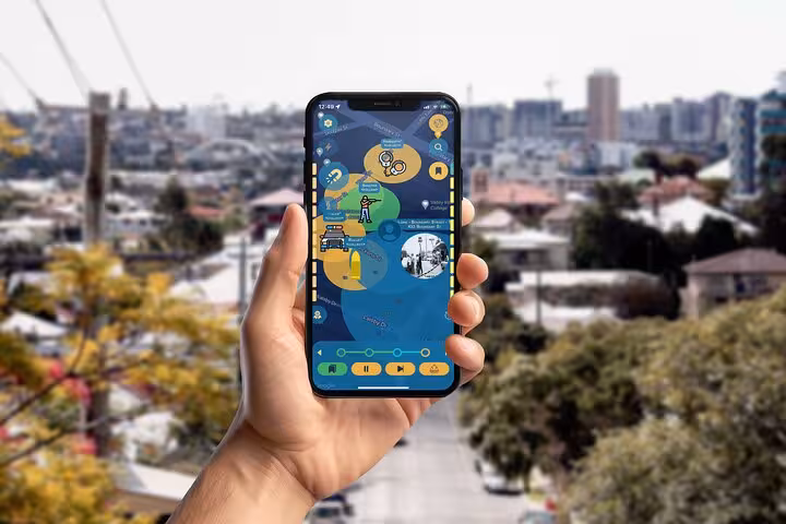 Hand holding smartphone showing Brisbane self-guided dark history tour app with panoramic suburb skyline view