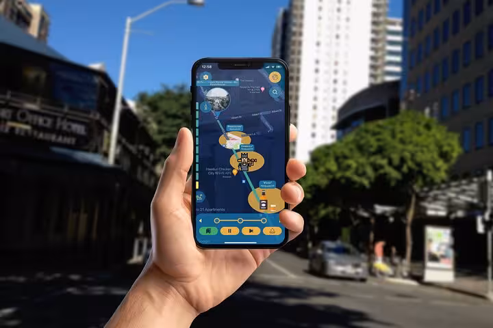 Hand holding smartphone displaying Brisbane dark history self-guided walking tour app map on city street
