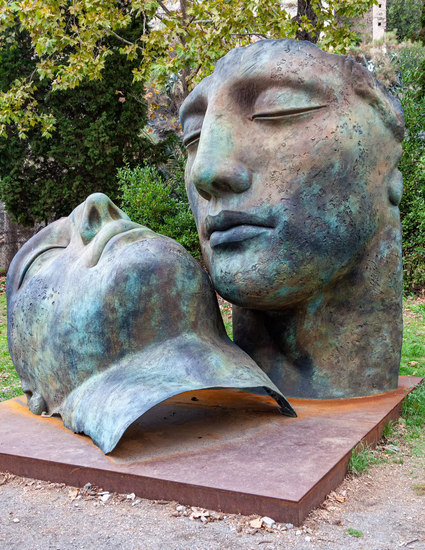 Large bronze face sculpture in Naples park, artistic stop before Pompeii half day group tour from Naples