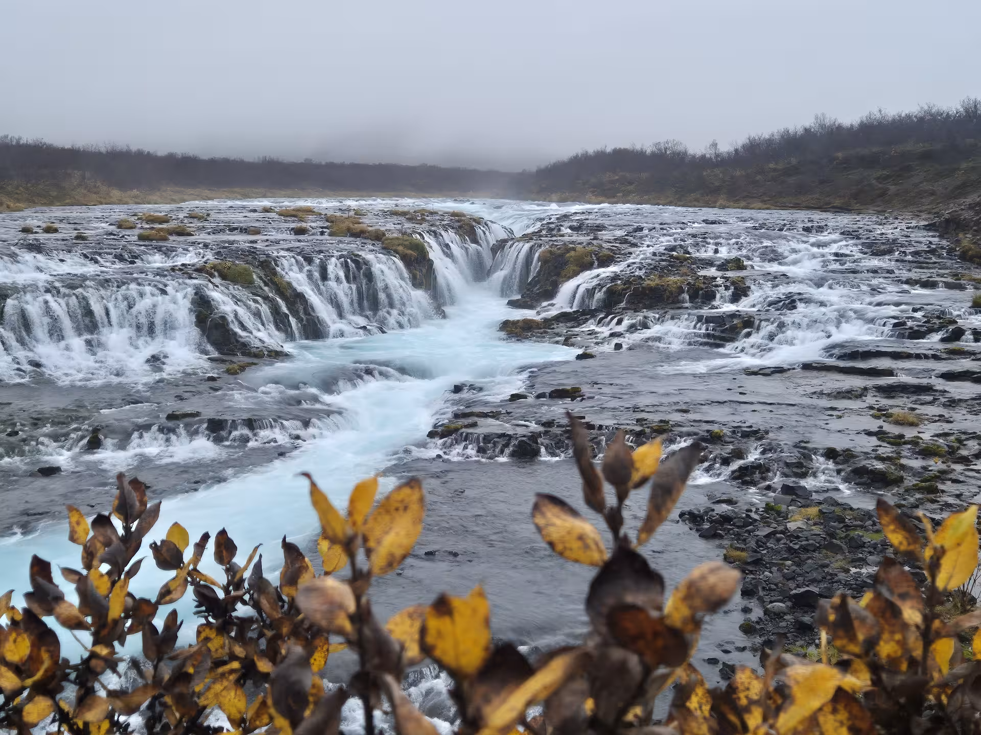 Bruarfoss waterfall with turquoise glacial water cascading over rocks on Iceland's Golden Circle route