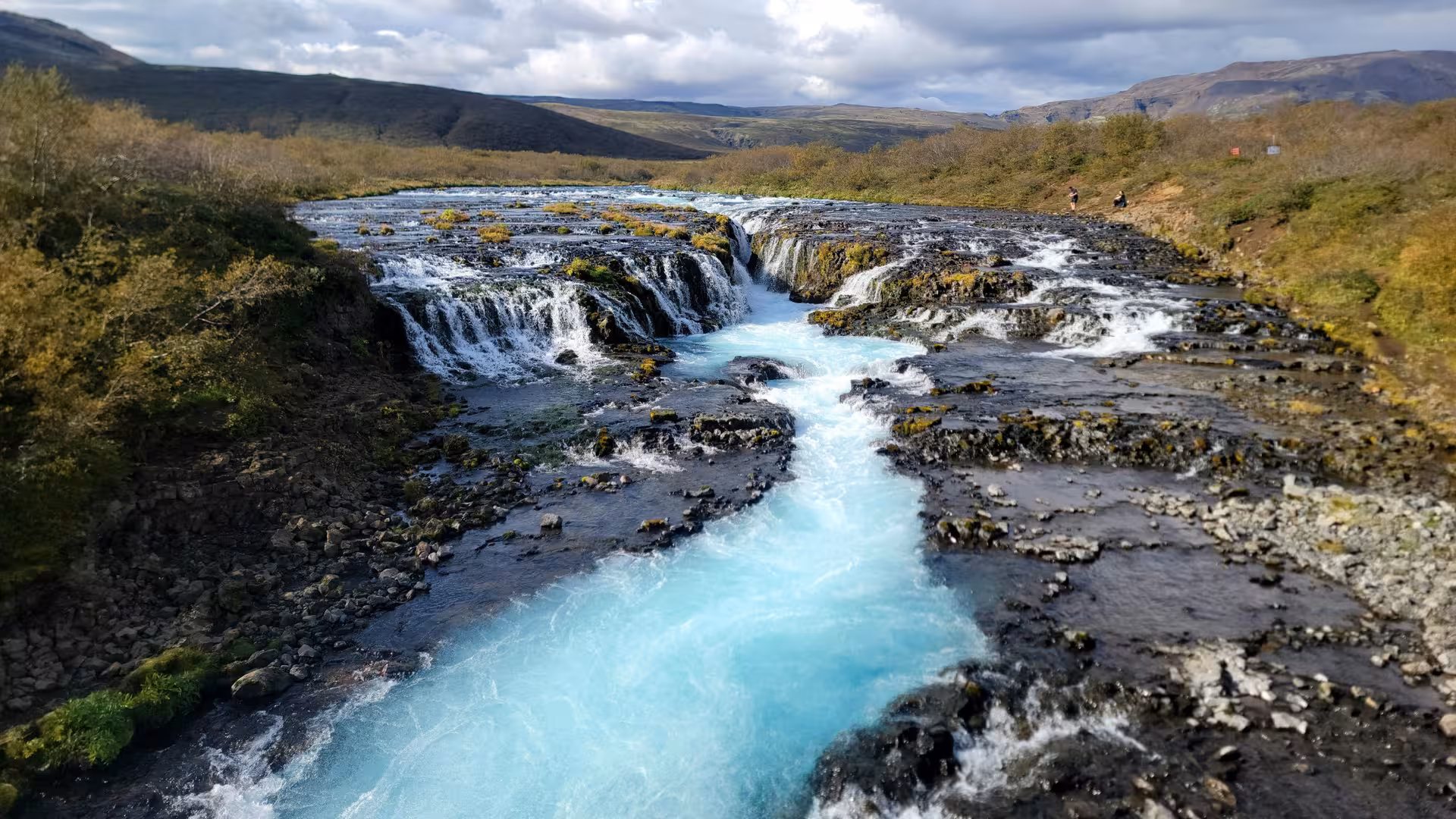 Stunning view of Bruarfoss waterfall's vivid blue waters cascading through Iceland's picturesque Golden Circle.