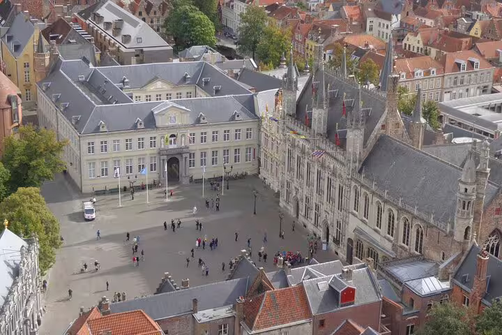 Aerial view of Bruges historic Burg Square with Gothic buildings and tourists, Belgium