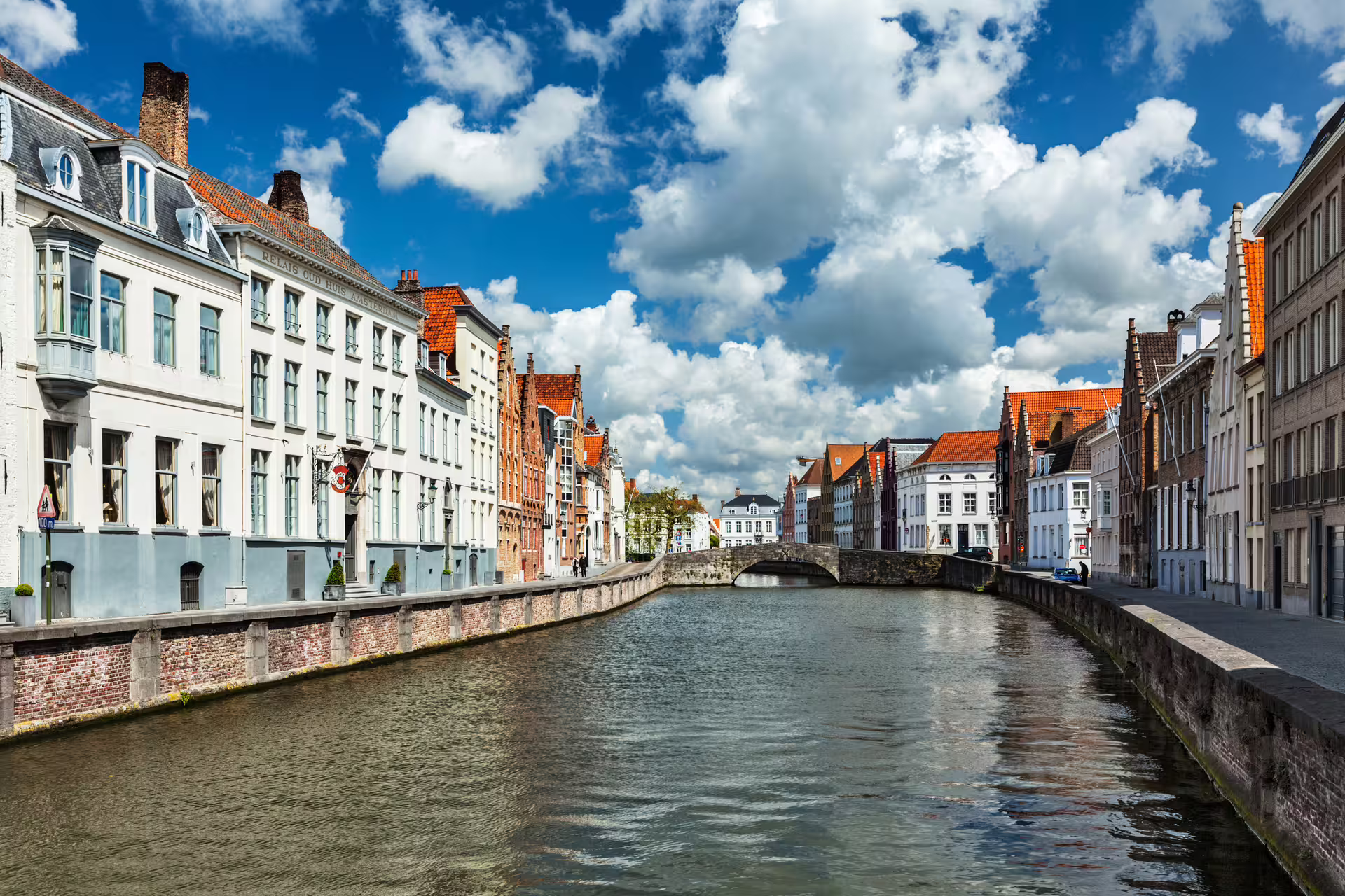 Scenic canal view in Bruges with historic Flemish architecture, perfect for a private walking tour exploring Flanders' charm.