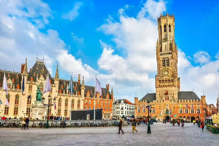 Bruges Market Square with Belfry tower on a sunny day, key landmark on a self-guided e-scavenger hunt tour