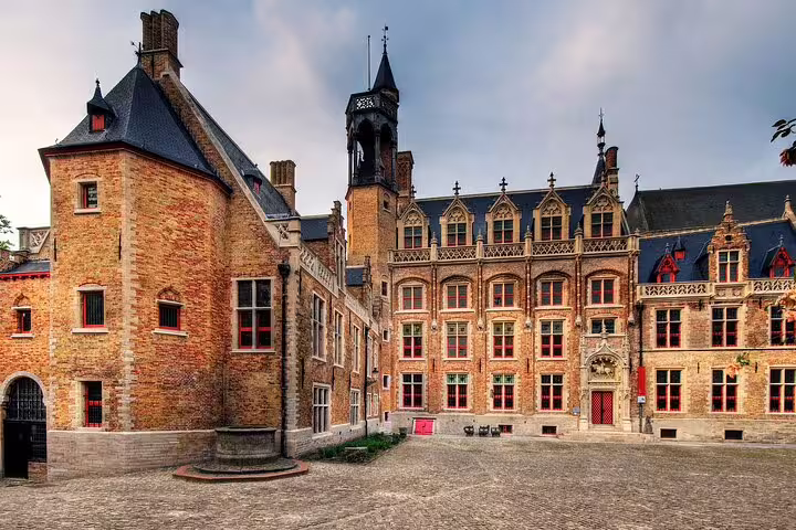 Historic medieval brick buildings and cobblestone courtyard in Bruges, Belgium