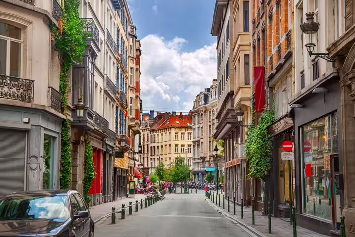 Charming narrow street lined with historic buildings and ivy-covered facades in Brussels city center