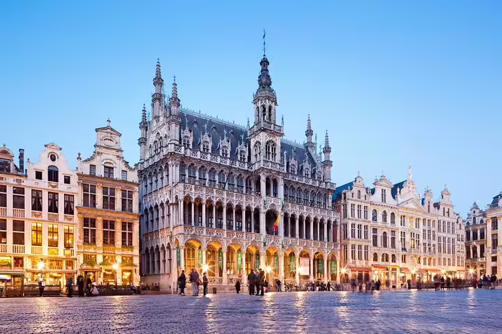 Grand Place Brussels illuminated historic guild houses and town hall at dusk