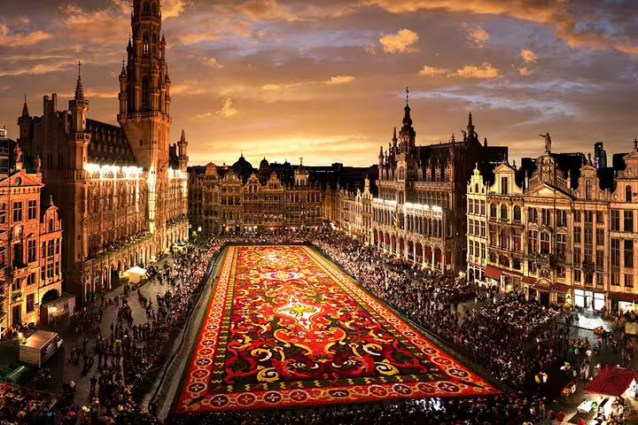 Aerial view of Brussels Grand Place flower carpet at sunset surrounded by historic guild houses