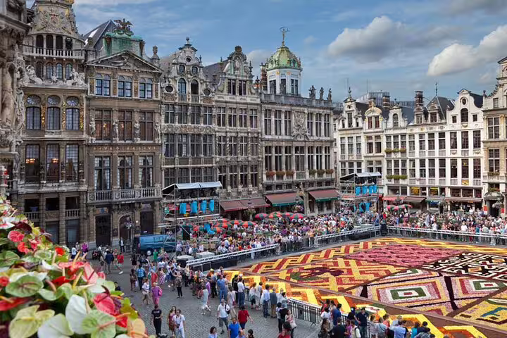 Grand Place Brussels flower carpet with ornate guild houses and crowds during full-day sightseeing tour
