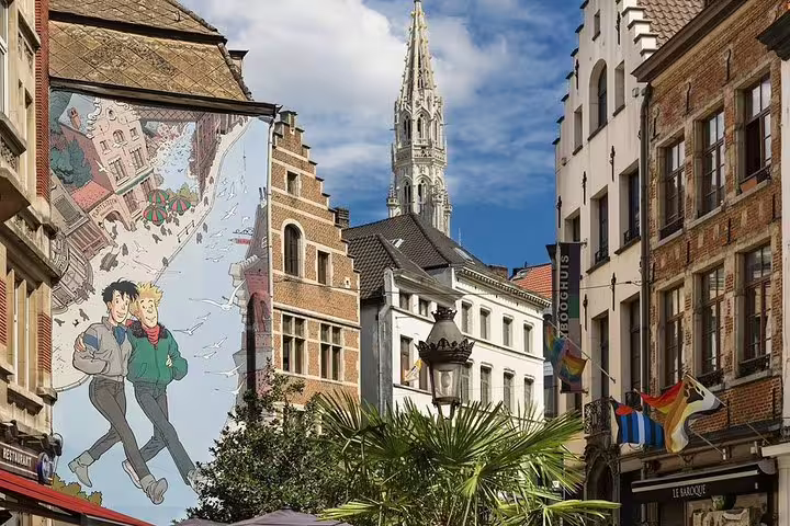 Brussels Old City street with comic mural and Gothic spire, ideal for a private half-day walking tour