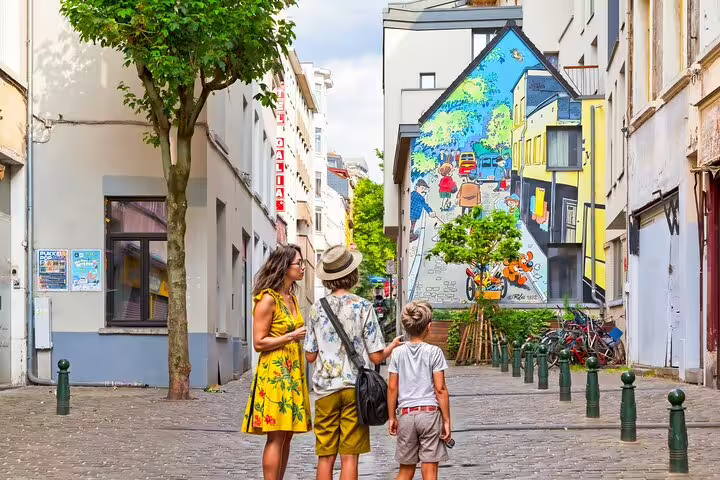 Family exploring a colorful mural on a charming street during a private local walking tour in Brussels, showcasing hidden gems.