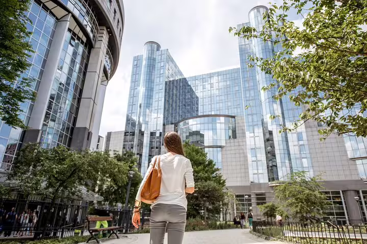 A woman explores modern architecture on a private walking tour in Brussels, discovering hidden gems and local insights.