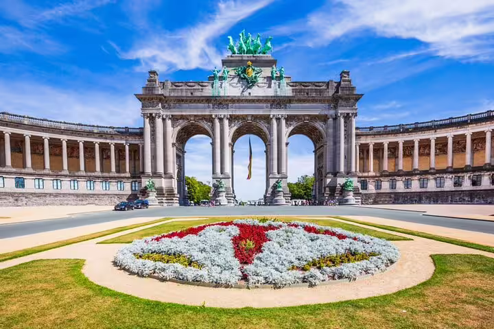 Triumphal Arch at Cinquantenaire Park in Brussels with colorful flower garden in foreground