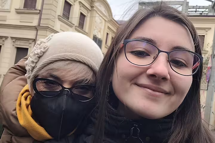 Two women smiling together on a Bucharest Old Town street tour