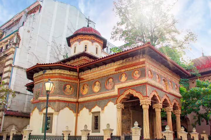 Ornate Romanian Orthodox church with colorful frescoes and arched portico in Bucharest Old Town