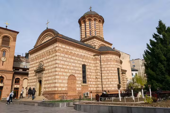 Historic brick Orthodox church with dome in Bucharest Old Town square