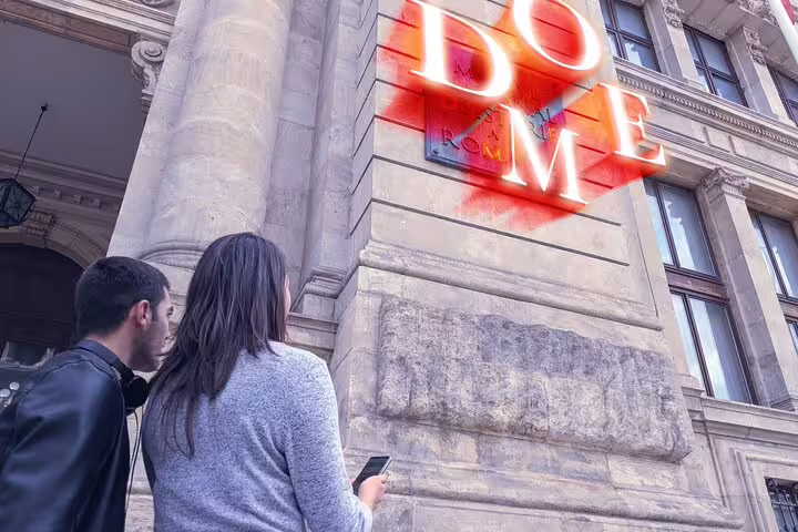 Two tourists using smartphone on self-guided treasure hunt tour in Bucharest Old Town historic building