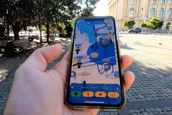 Explorer using a mobile tour app with an interactive map near a historic Bucharest square on a self-guided revolution tour