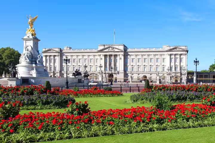 Buckingham Palace with Victoria Memorial and red flower gardens on a sunny day in London