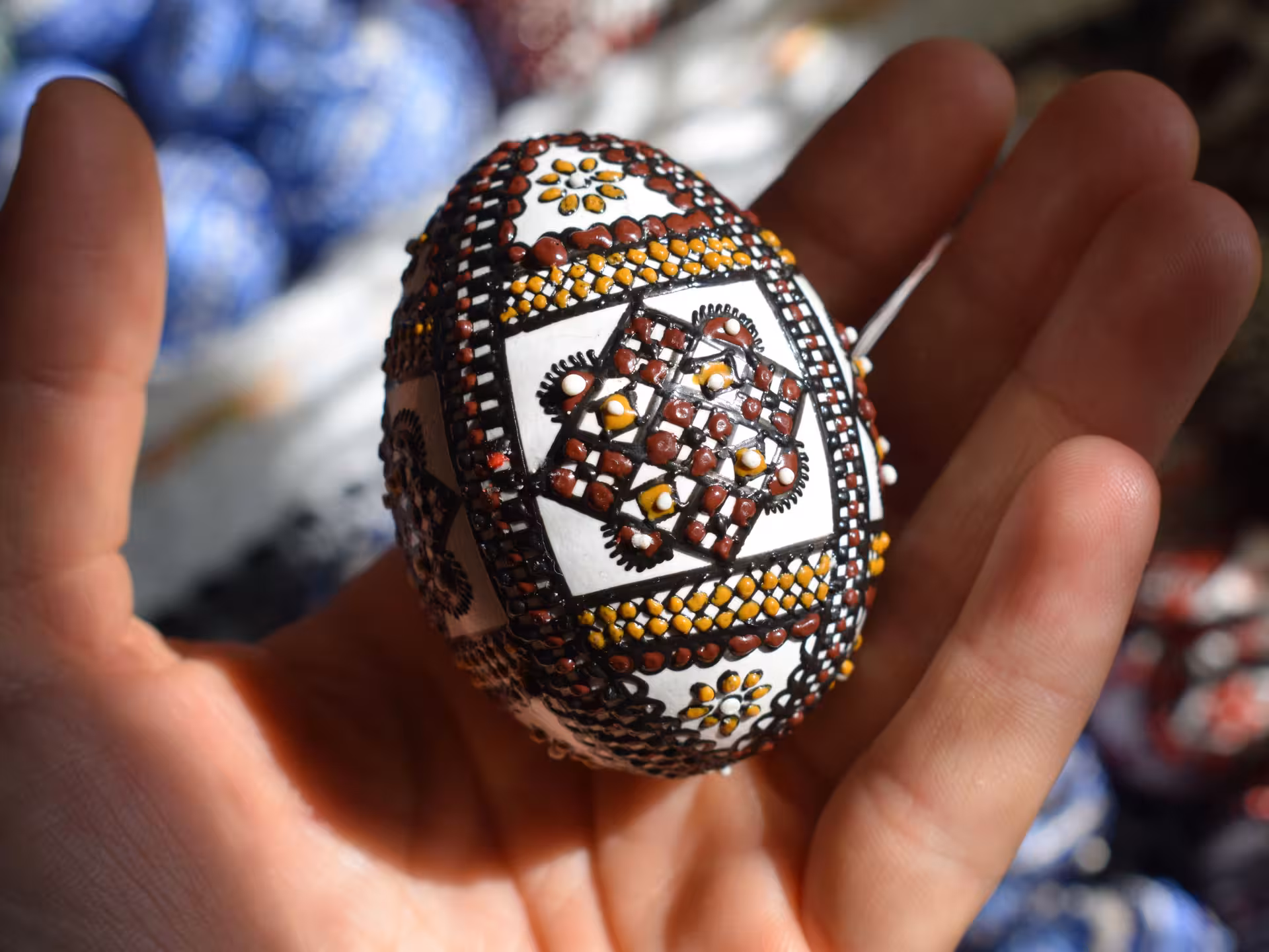 Intricately hand-painted traditional Bucovina Easter egg showcasing Romanian folk art on a guided cultural tour from Cluj