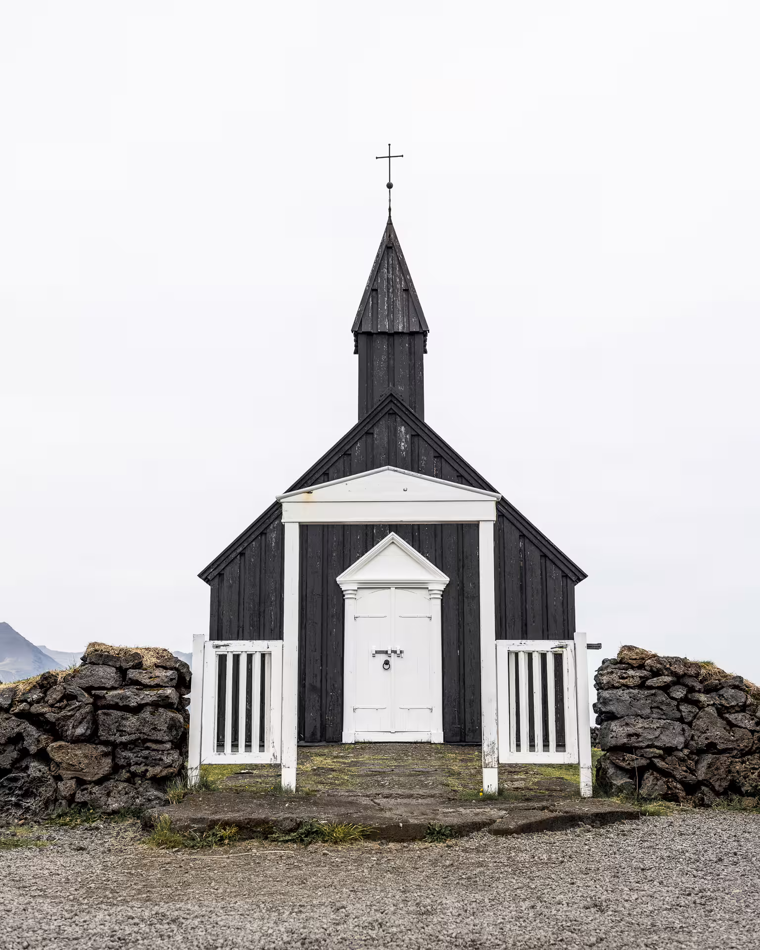 Black wooden Búðakirkja church with white door and steeple on Snæfellsnes Peninsula, Iceland