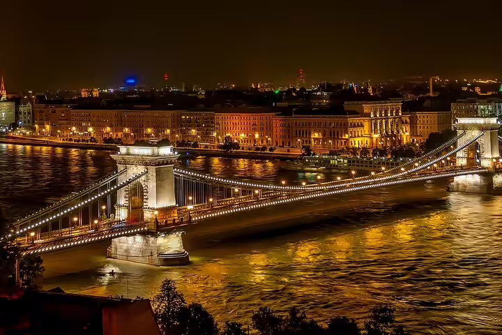 Illuminated Chain Bridge and Danube River in Budapest at night, showcasing stunning cityscape views on a night tour.