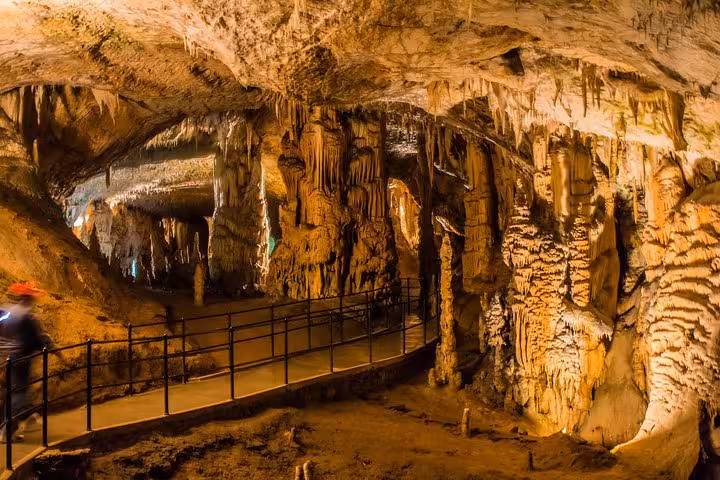 Guided cave walkway with stalactites and stalagmites, a scenic stop on the Budapest to Dubrovnik tour