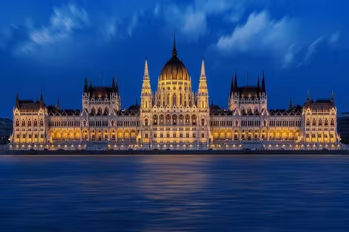 Hungarian Parliament Building lit at night on the Danube, highlight of a private day trip to Budapest from Vienna