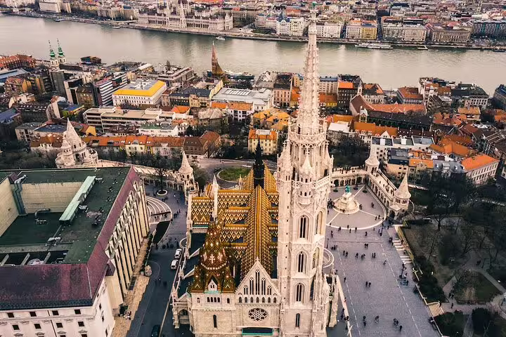 Aerial view of Matthias Church and Fisherman's Bastion in Budapest with the Danube River in background