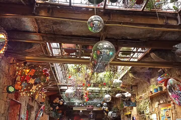 Ruin bar interior in Budapest with disco balls and eclectic decor, featured on a private modern city tour