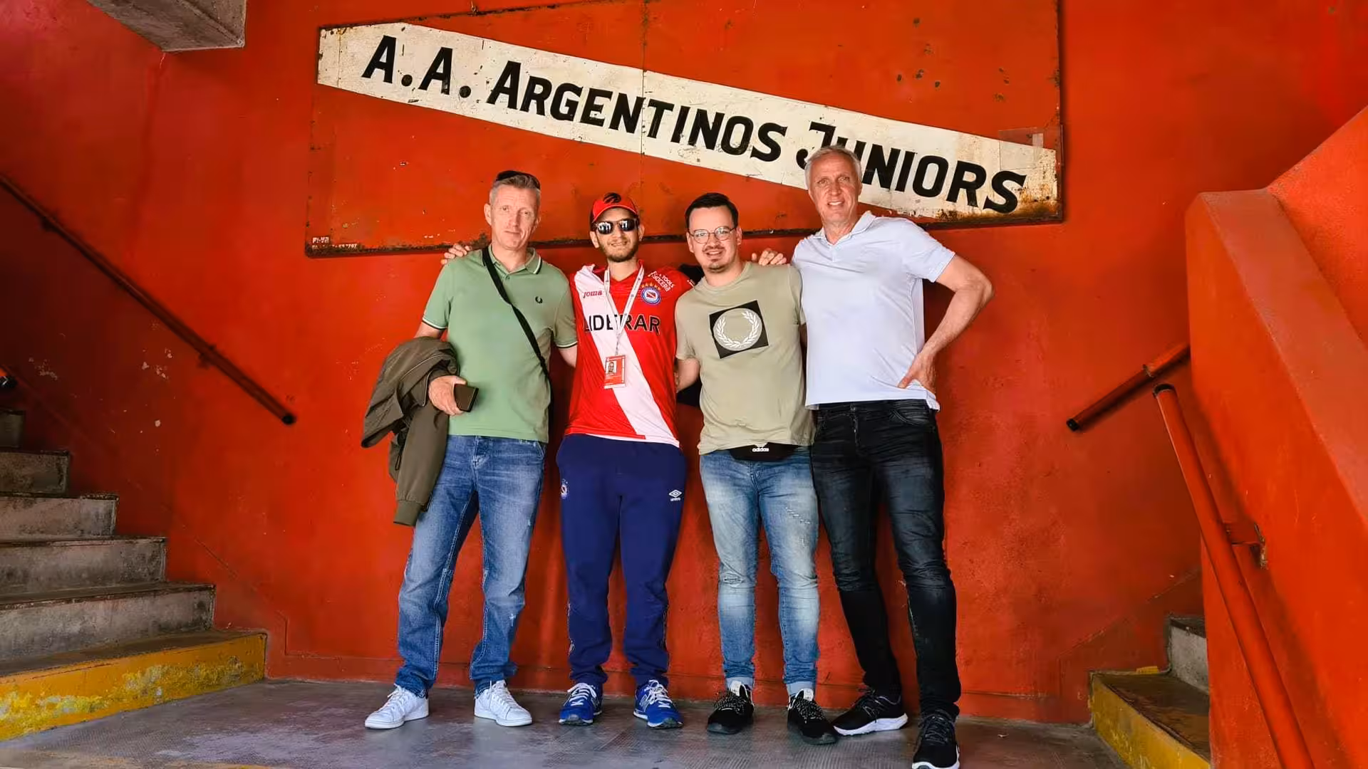 Travelers pose with local guide at Argentinos Juniors stadium on Buenos Aires soccer matchday experience