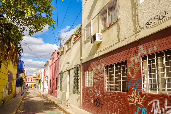 Colorful street with graffiti-covered brick buildings in Buenos Aires neighborhood