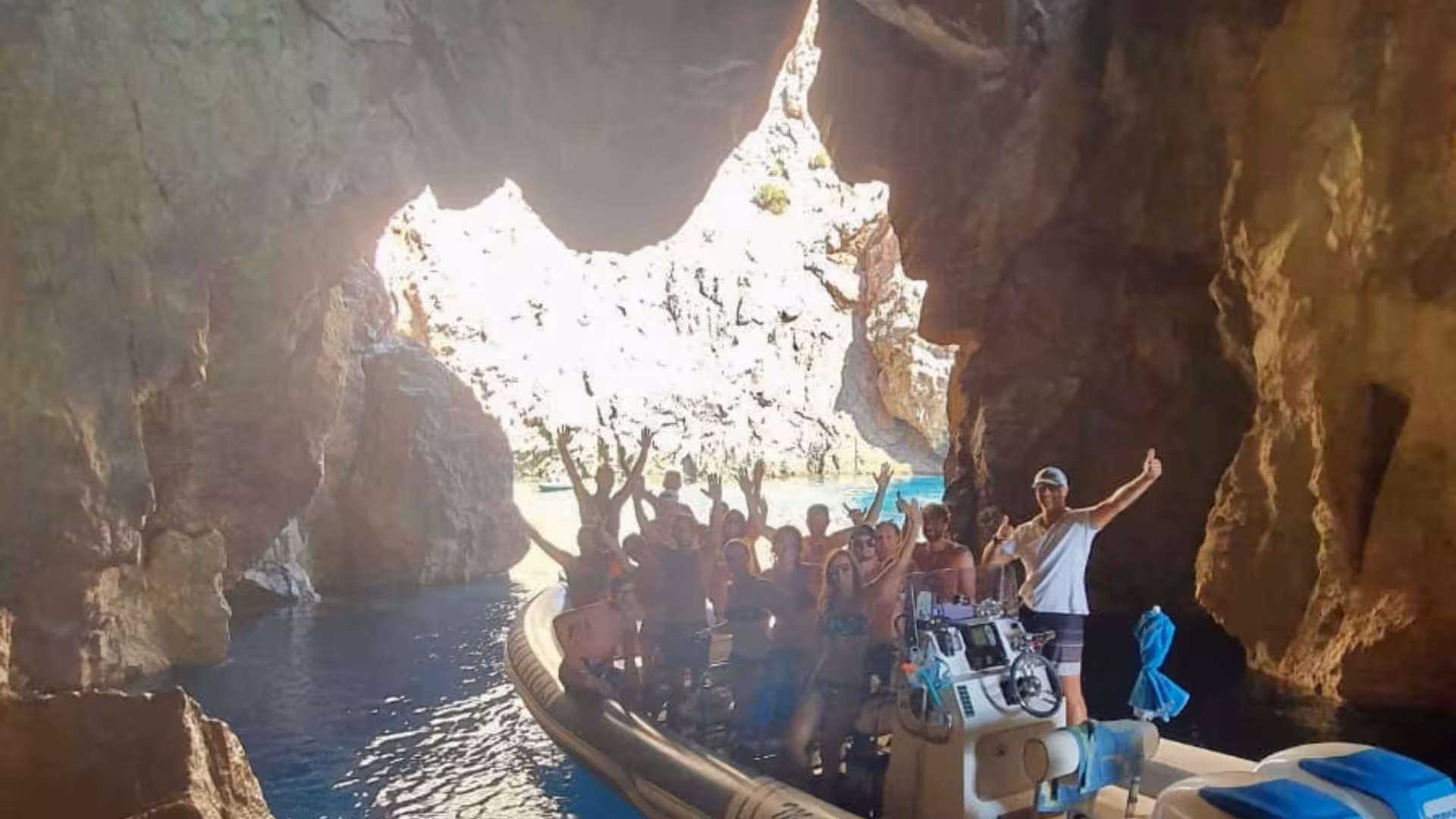 Group enjoying a thrilling dinghy tour through a dramatic cave near Buggerru, showcasing adventure and natural beauty.