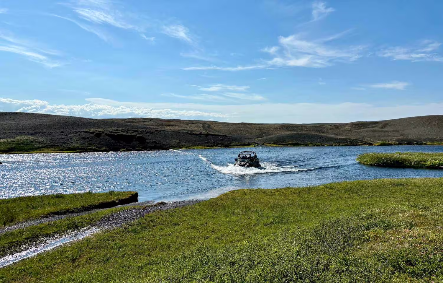 Buggy crossing a river in the Icelandic highlands near Landmannalaugar on a sunny day