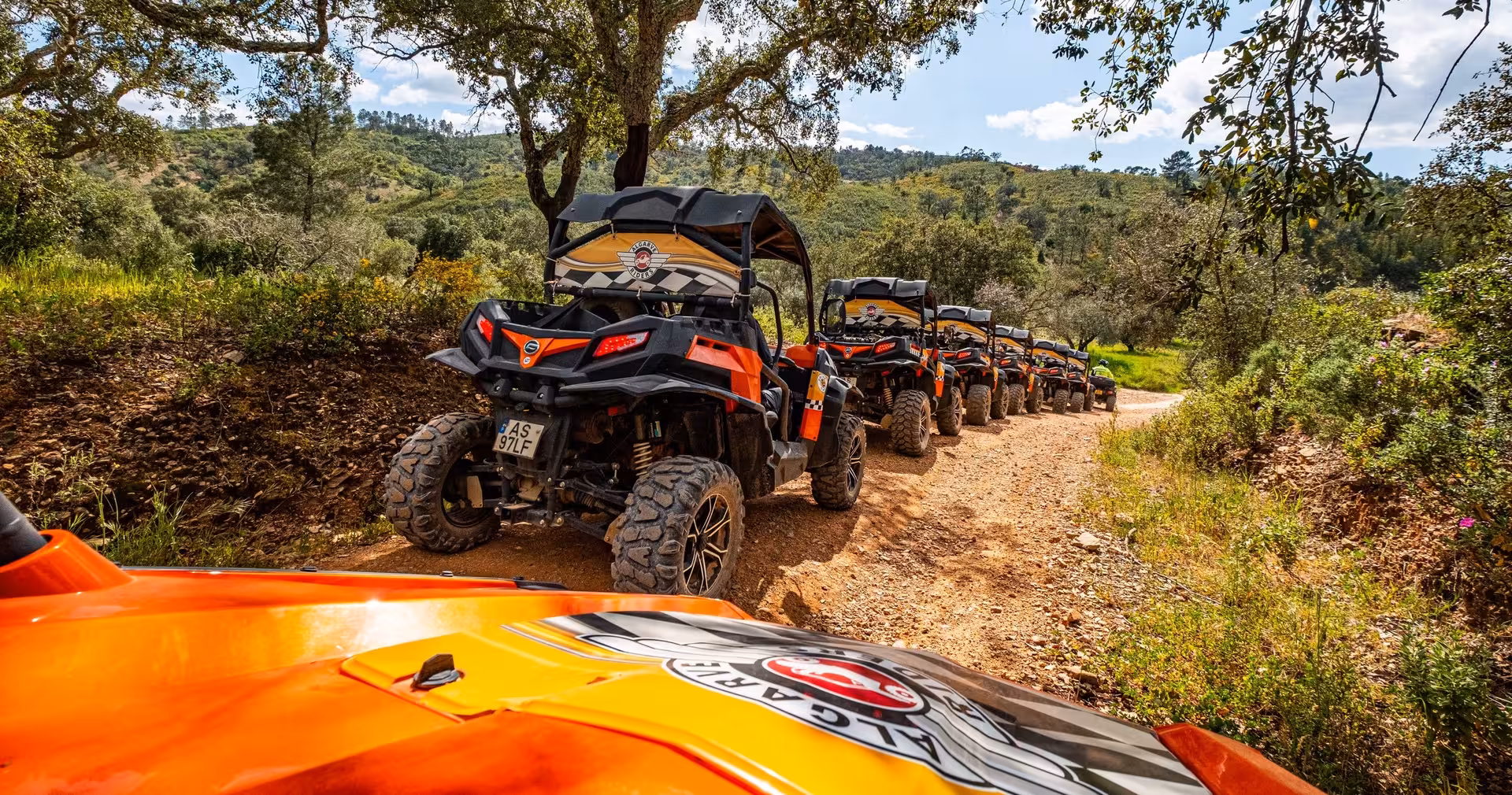 Guided buggy tour driving in convoy along a rugged forest trail, exploring Algarve off-road adventure terrain