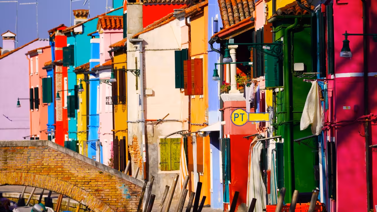 Vibrant Burano canal houses in rainbow colors, iconic Venice lagoon stop on Burano & Mazzorbo tour