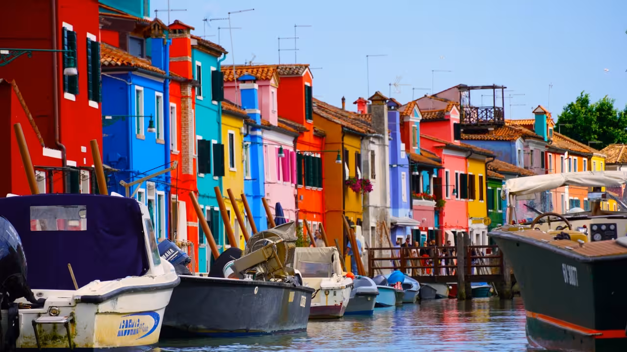 Colorful Burano canal with vibrant houses and boats, Venice lagoon tour to Burano and Mazzorbo lace heritage