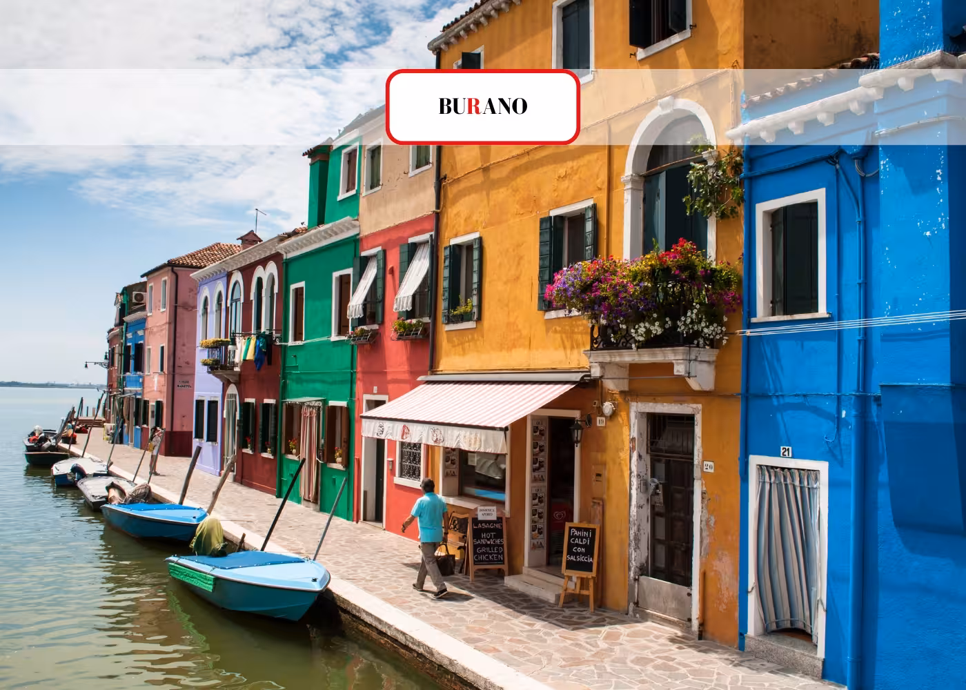 Colorful Burano street with vivid houses and canal-side boats, capturing the island's iconic and lively atmosphere.